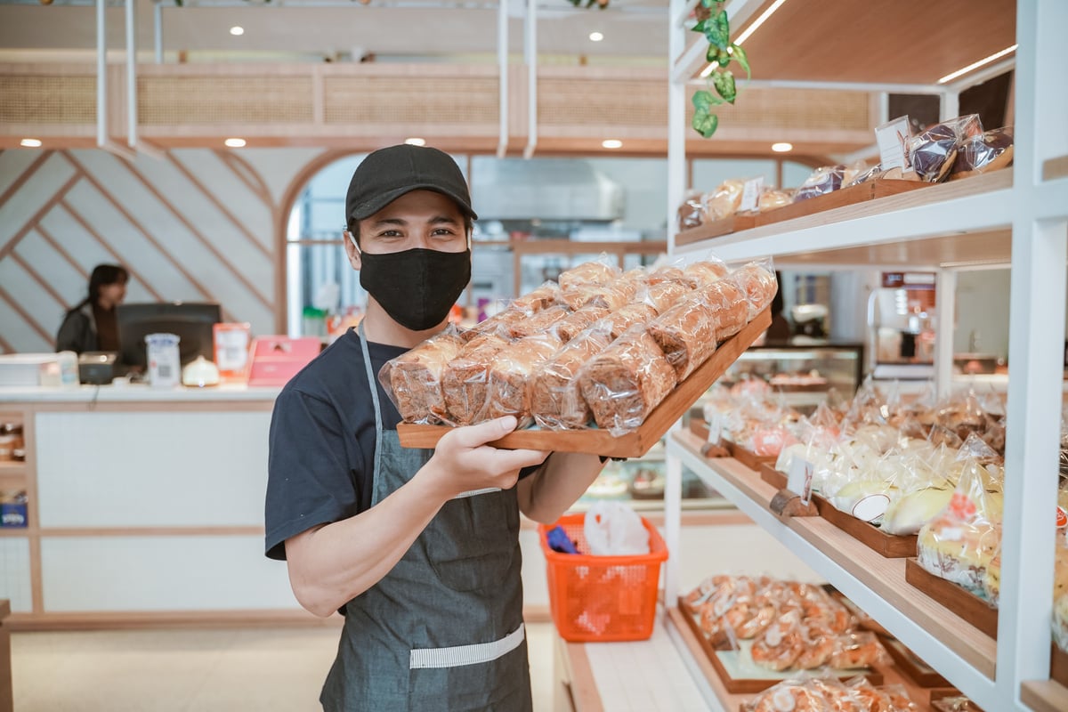 Handsome Asian Smiling Worker at the Bakery Shop